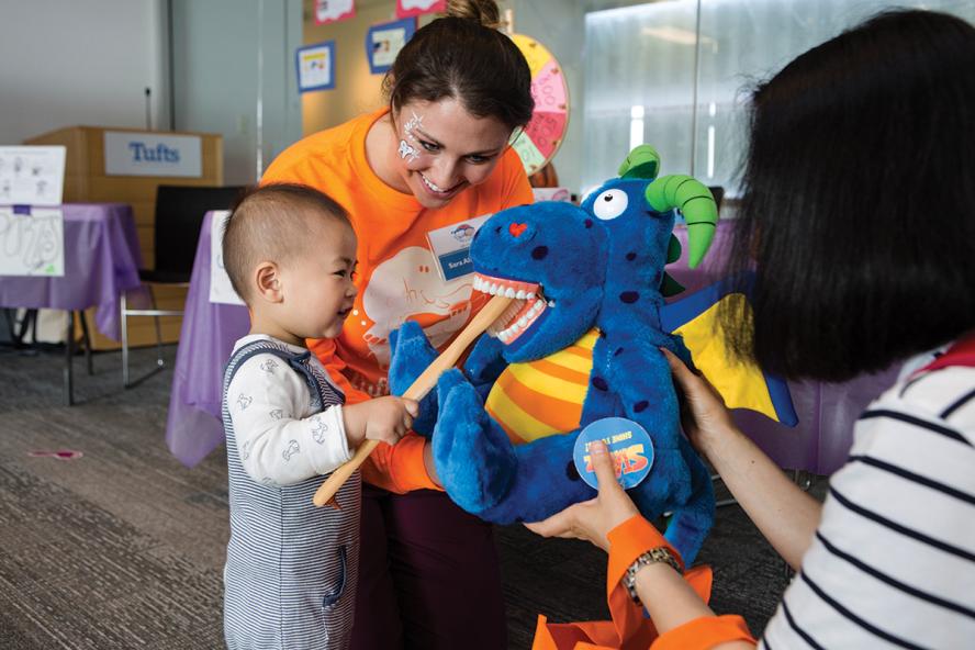 Tufts University School of Dental Medicine students on the Tufts Smile Squad teach children about tooth brushing