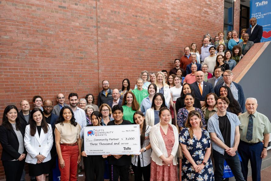 People holding a large check from Tufts Community Grants