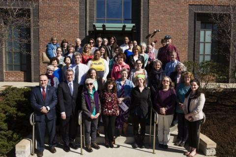 President Tony Monaco stands with 36 local community organization representatives after being awarded a $21,000 grant from the Tufts Neighborhood Service Fund.
