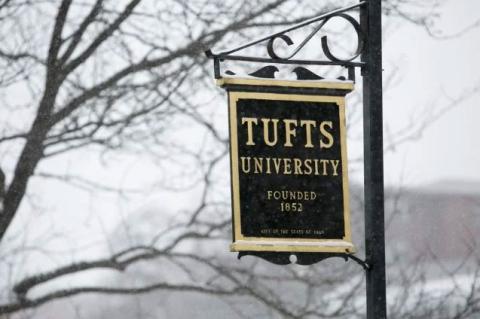 The Tufts sign on Curtis Street in Somerville, Massachusetts stands amid a backdrop of snow.