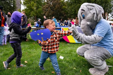 Jumbo high fives a young visitor during Community Day.