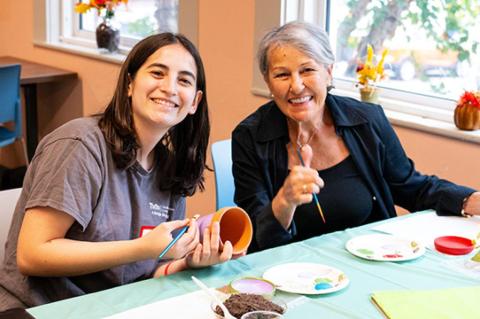 a Tufts student and a Somerville resident work on a craft project at the Somerville Council on Aging’s Senior Center